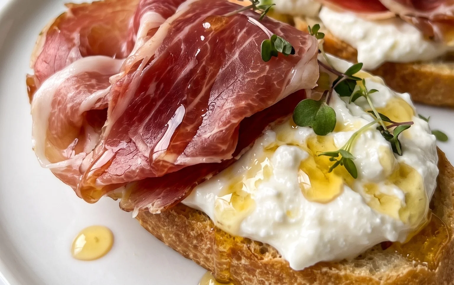Beef Prosciutto Crostini with Burrata and Lemon Honey Drizzle